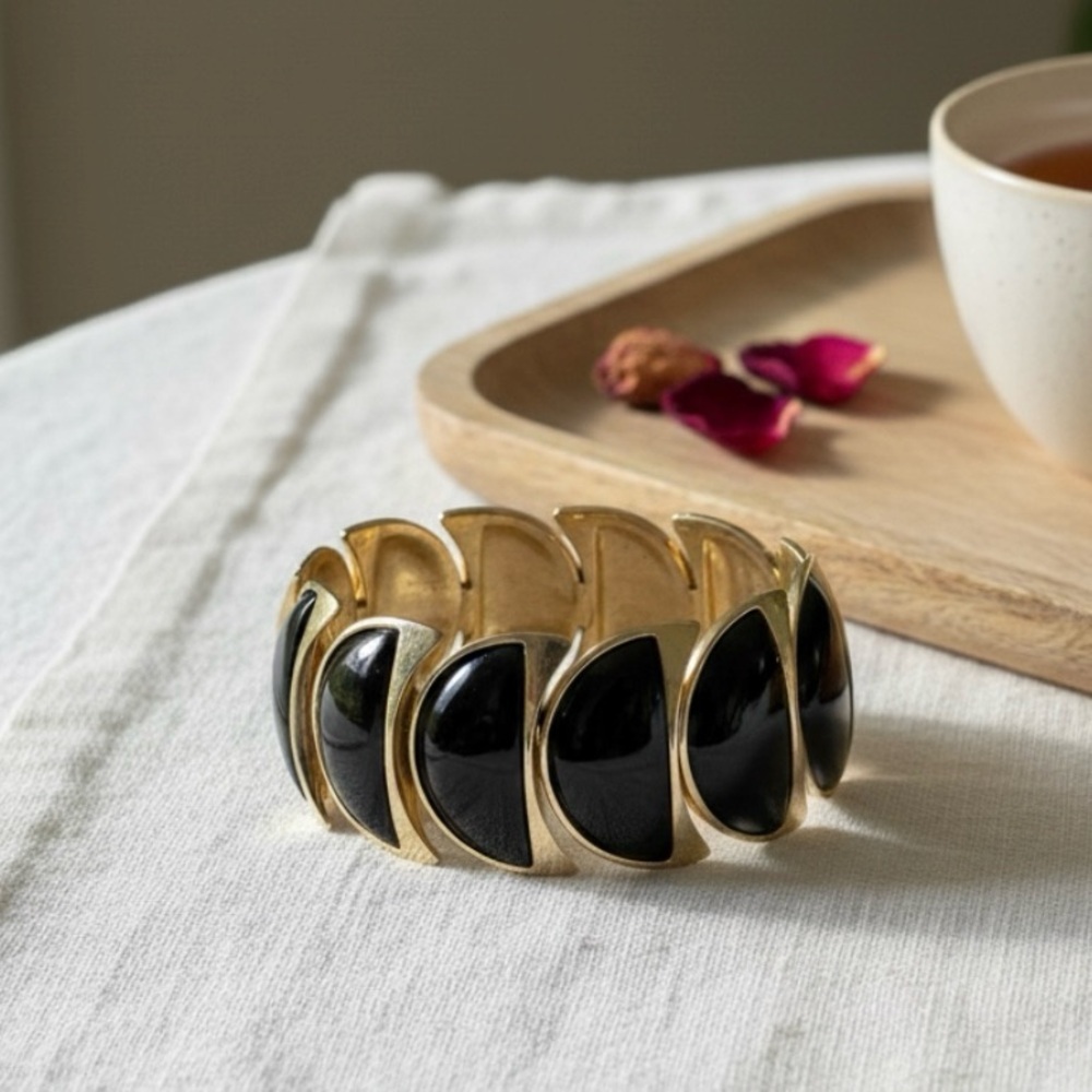 Black enamel gold tone stretch bracelet